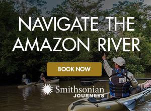 Photo of Smithsonian Journeys travelers kayaking along the Amazon River with a Smithsonian Journeys Expert